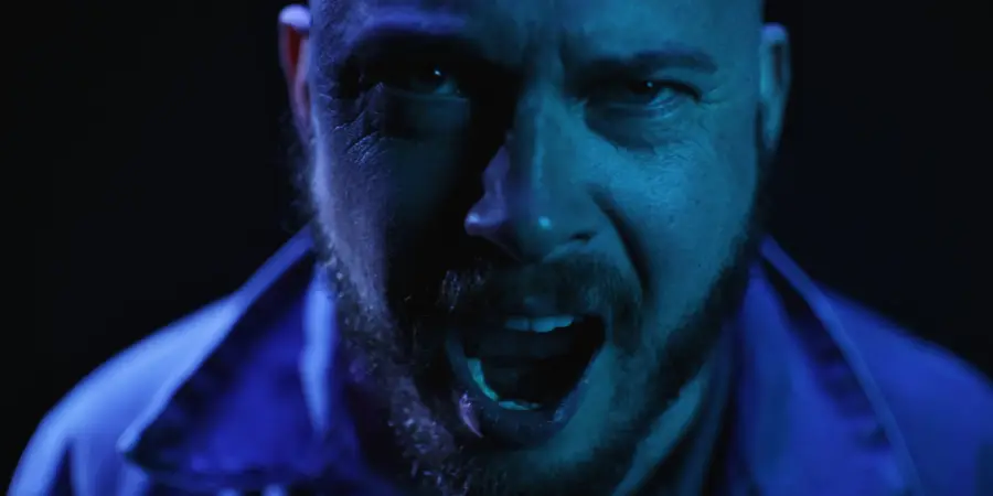 Box of Rules: blue-lit close-up, shouting