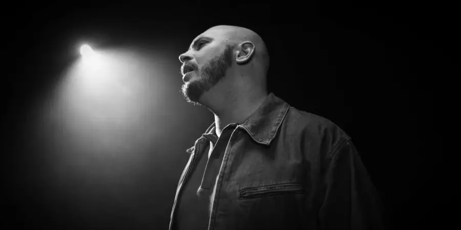 Box of Rules: black-and-white profile under a single spotlight